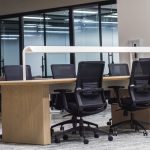 black office rolling chair beside brown wooden desk